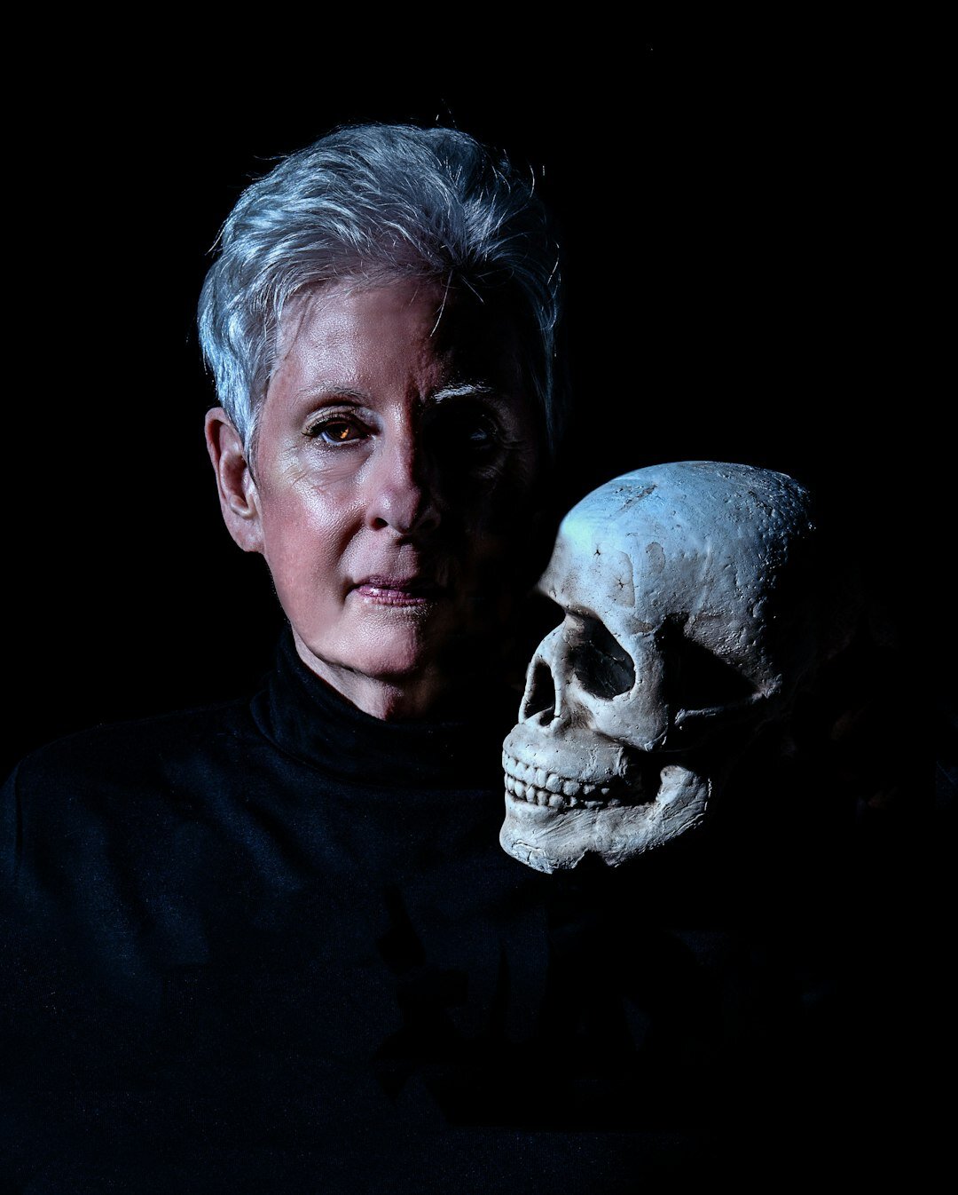 Studio portrait of a middle-aged German woman researcher with short grey hair
