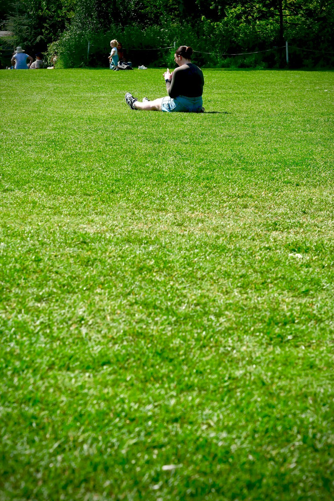 person reading book in park