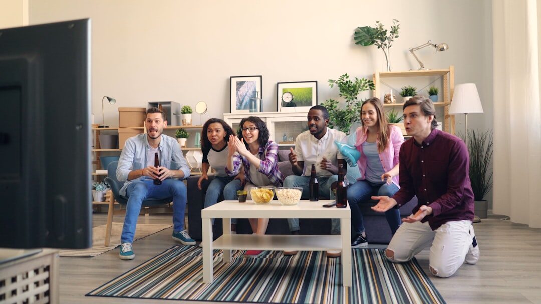 group of fans watching tv